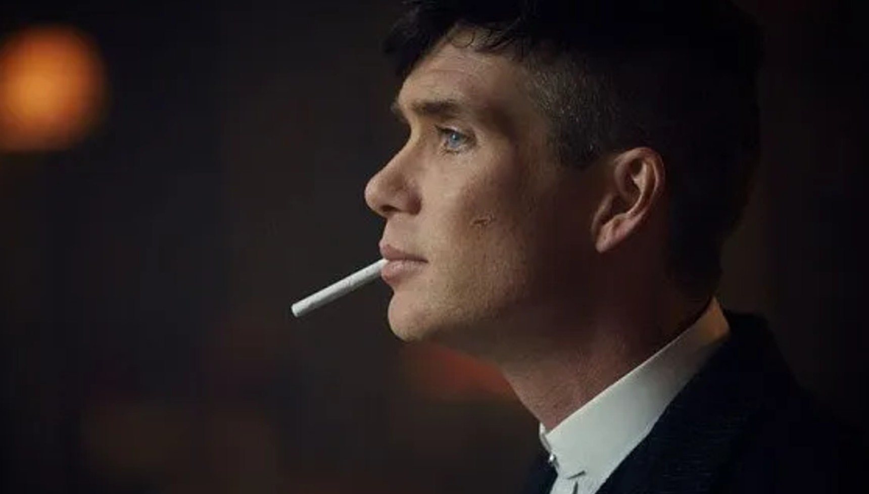 Cillian Murphy with a cigarette in his mouth in Peaky Blinders