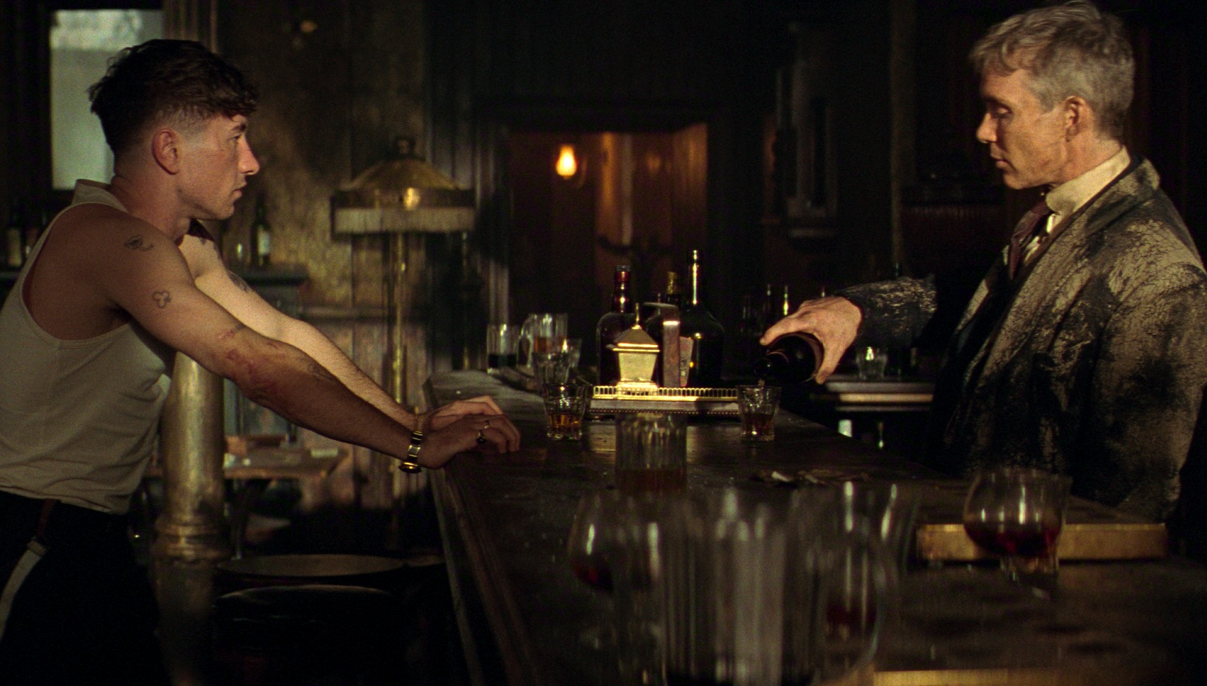 Barry Keoghan and Cillian Murphy pouring a drink in the Peaky Blinders movie