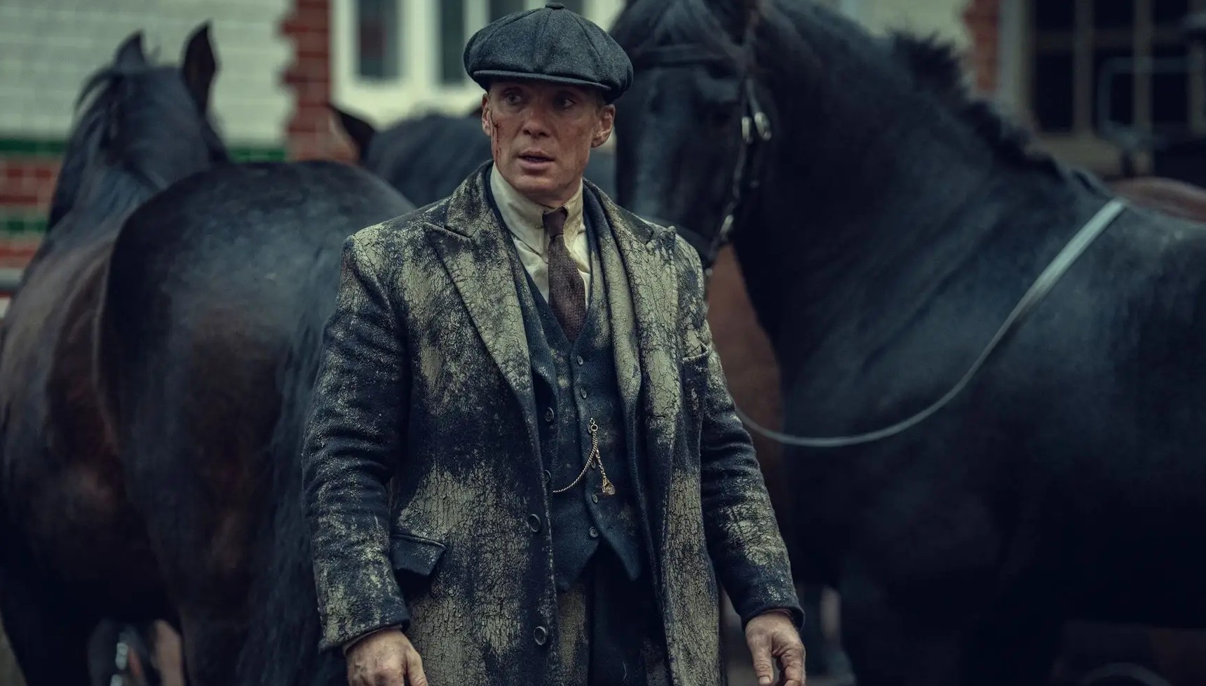 Tommy Shelby next to two horses in Peaky Blinders: The Immortal Man