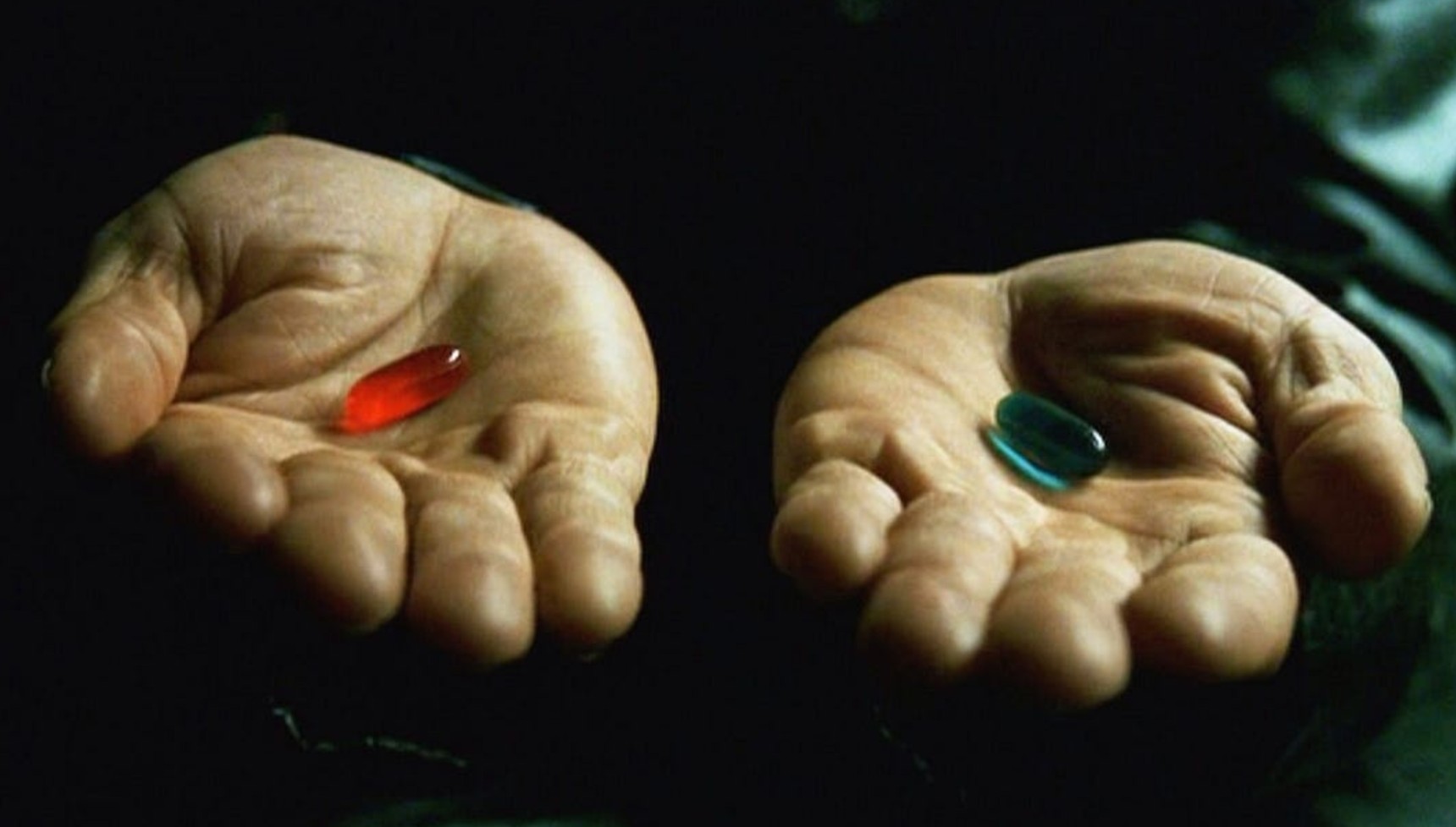 Morpheus holding the red and blue pill in The Matrix
