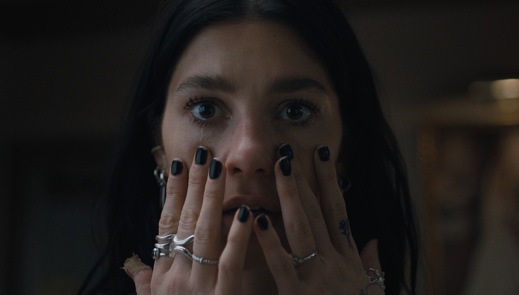 Rachel in Something Very Bad Is Going to Happen with her hands on her face