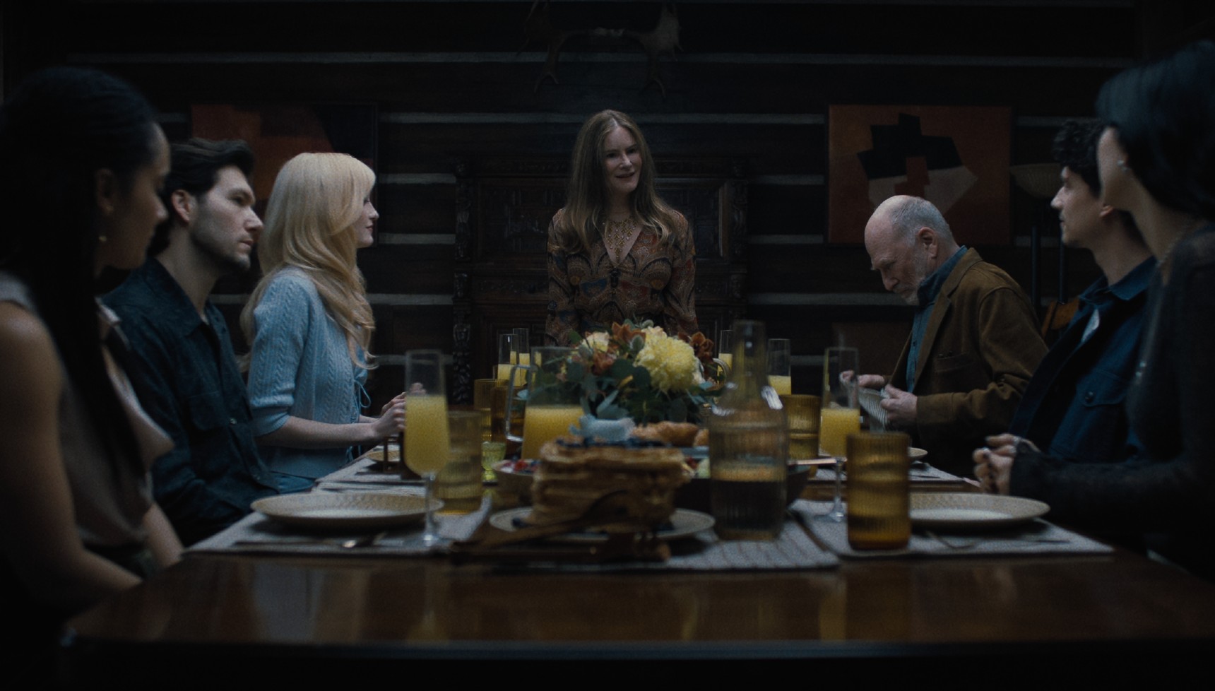 A family sitting at the dinner table in Something Very Bad Is Going to Happen