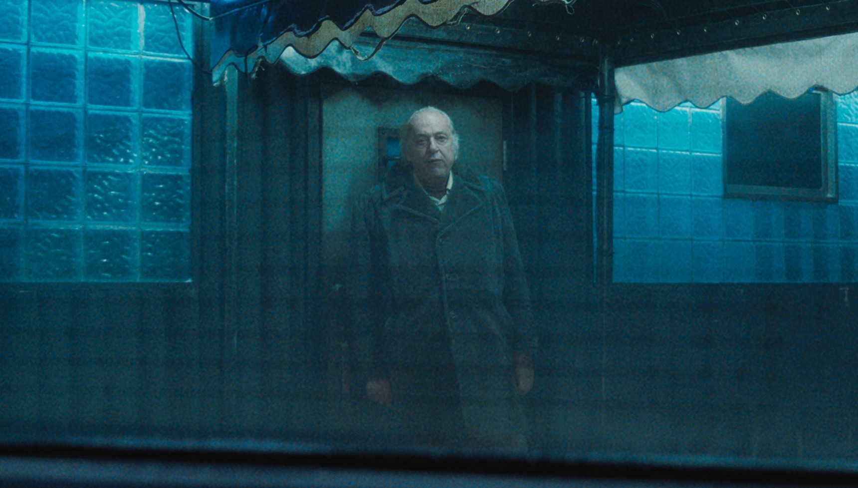 The Witness standing behind a car window in Something Very Bad is Going to Happen 