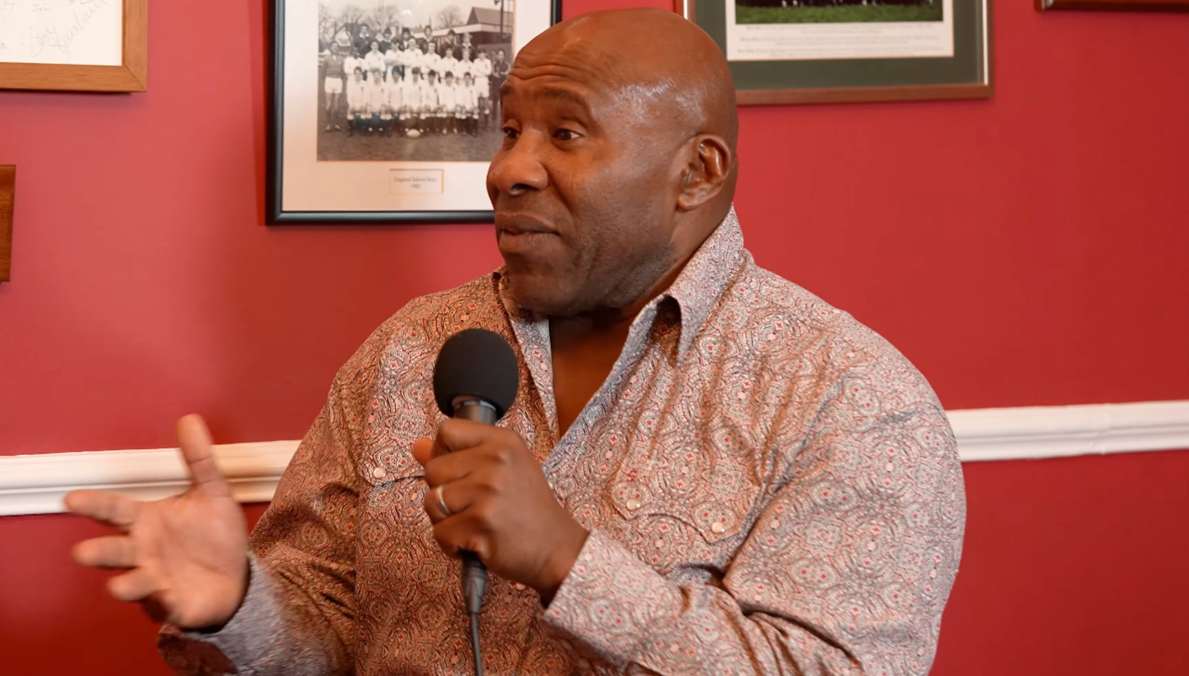 Victor Ubogu holding a microphone