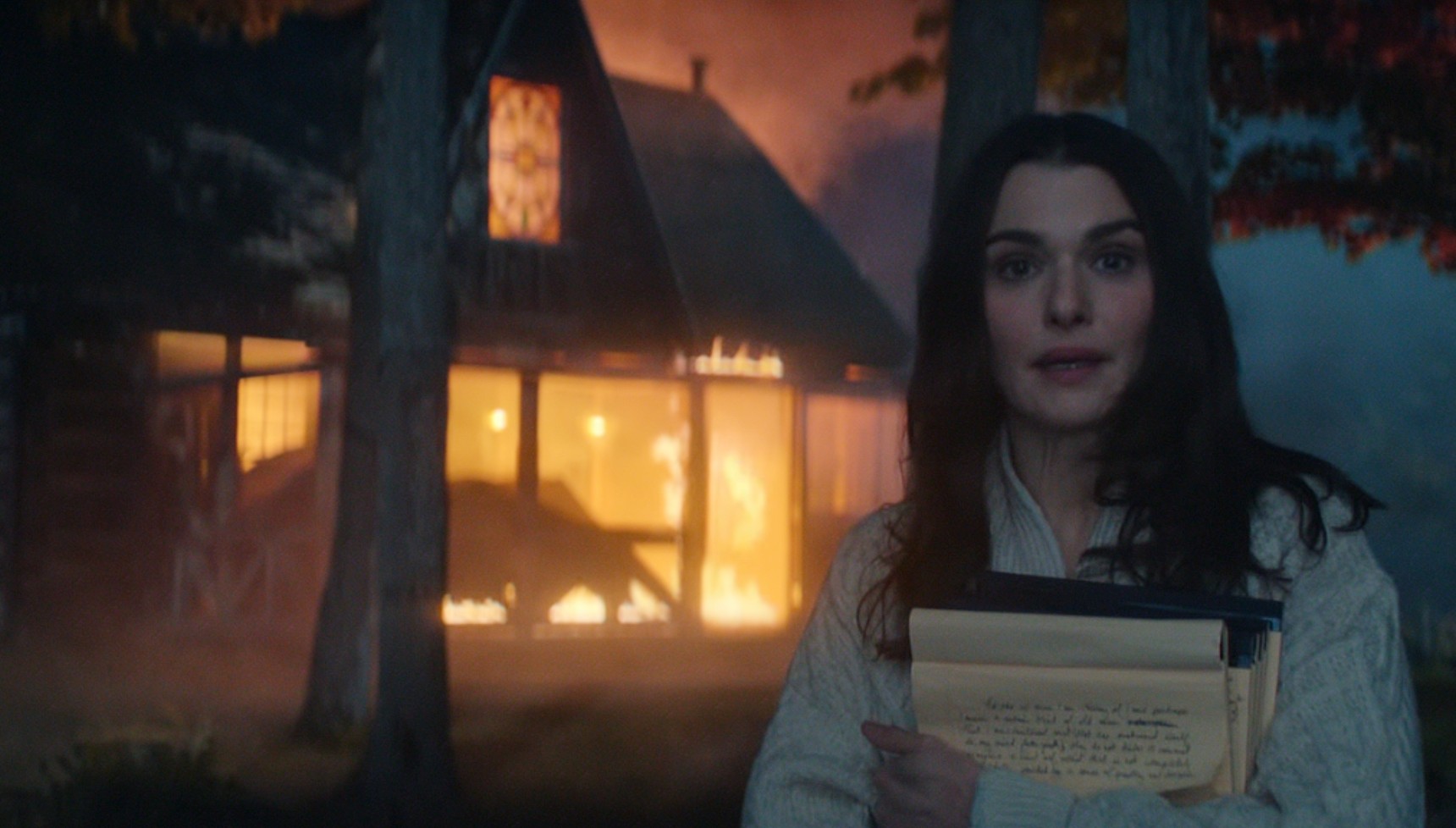 Rachel Weisz standing in front of a burning building in Vladimir