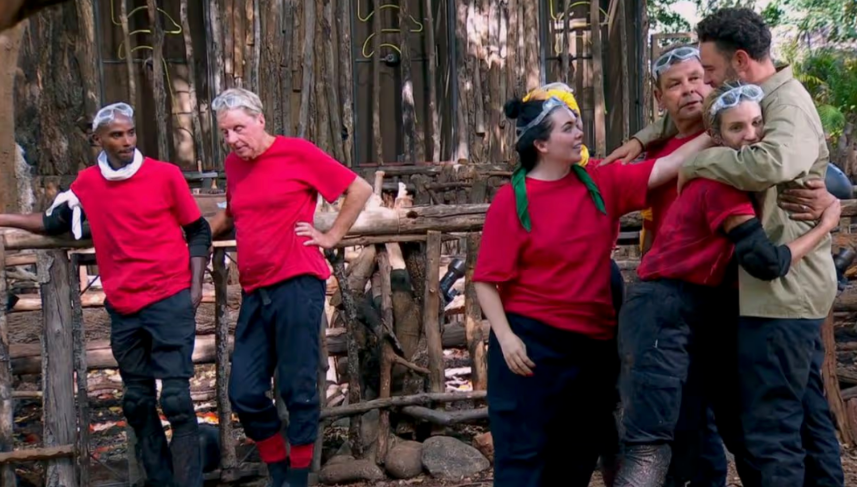 Harry and Mo standing away from the rest of the campmates