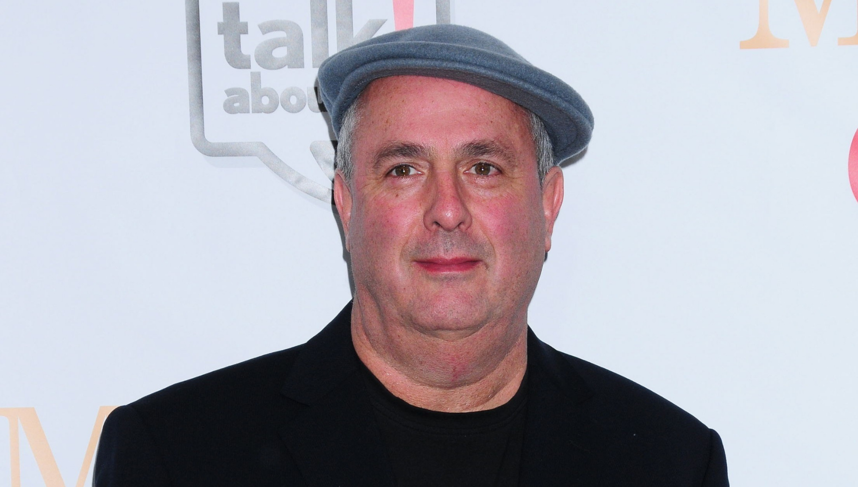 Roger Michell wearing a cap