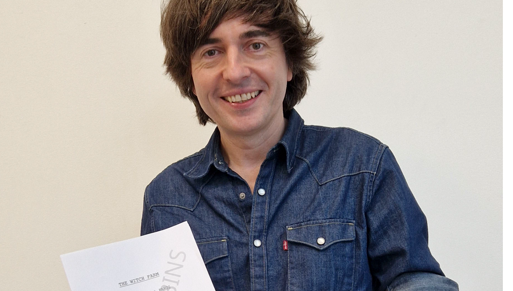 Danny Robins holding the script for The Witch Farm