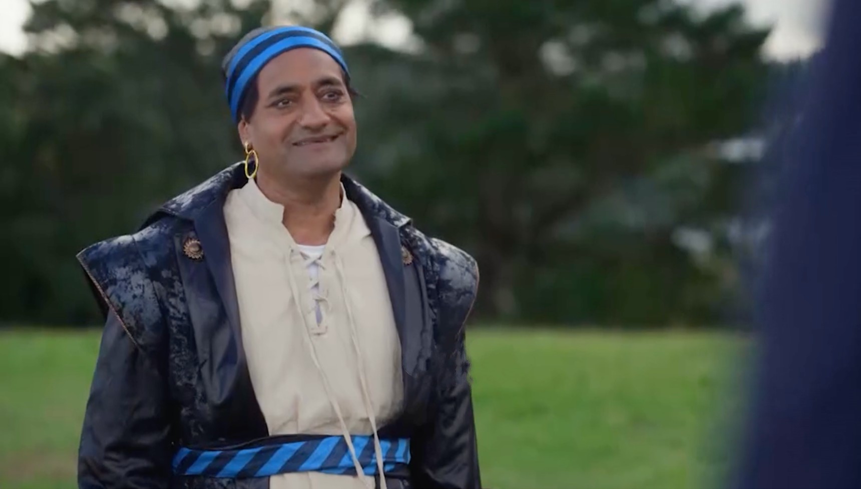 Narinder Samra as Sanjeev Desai and Dev Desai in Beyond Paradise