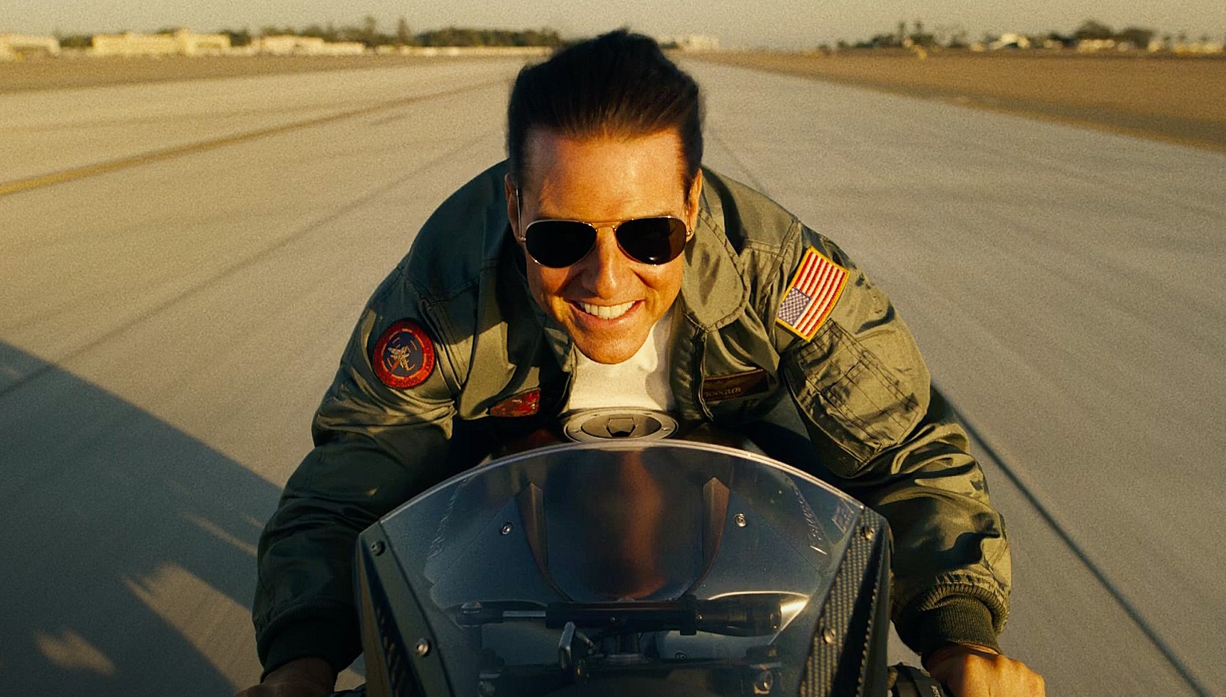 Tom Cruise riding a motorbike in Top Gun: Maverick