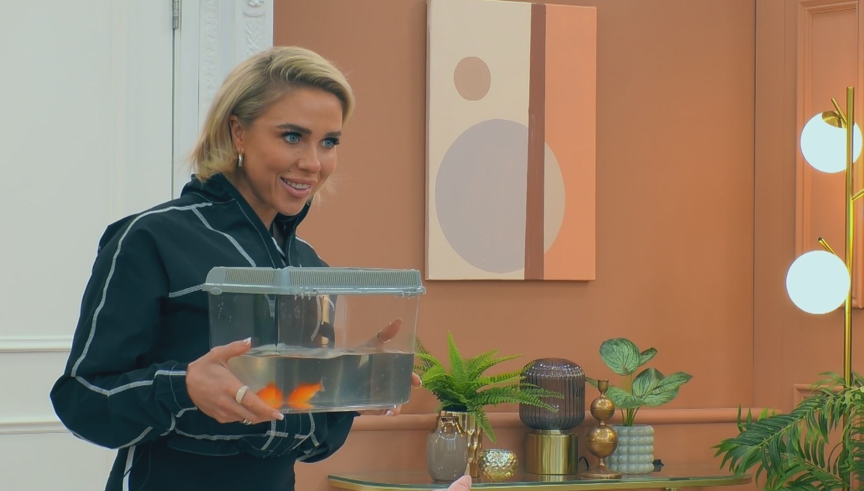 Gabby Allen with goldfish in tank