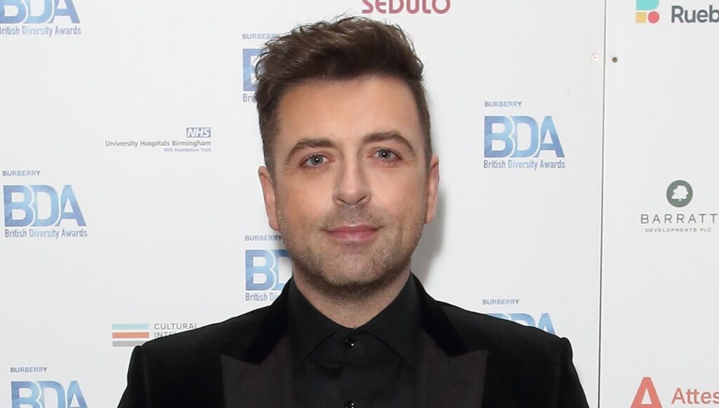 Mark Feehily on a red capret 