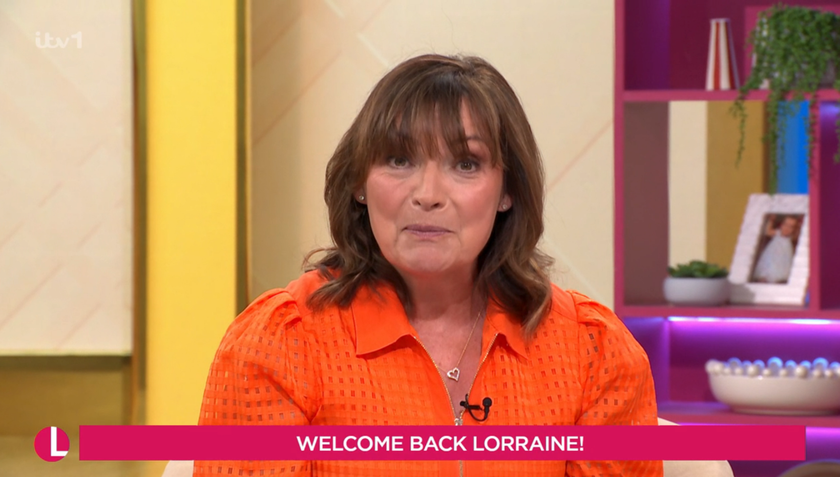 Lorraine Kelly wearing an orange top
