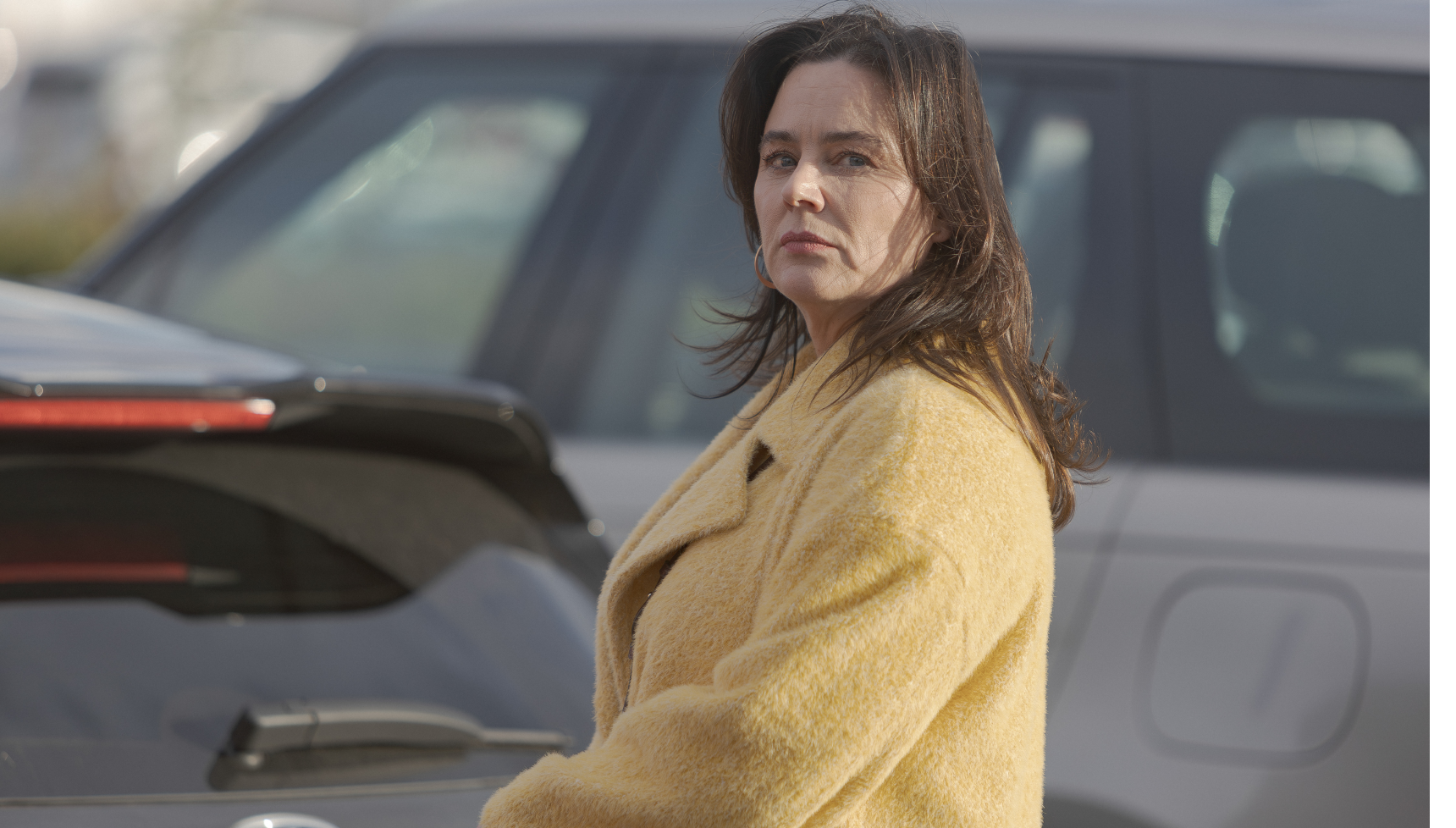Jill Halfpenny as Lucy Logan in yellow coat