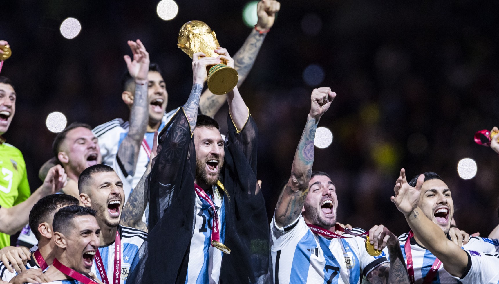 Lionel Messi holding the World Cup with the Argentina team