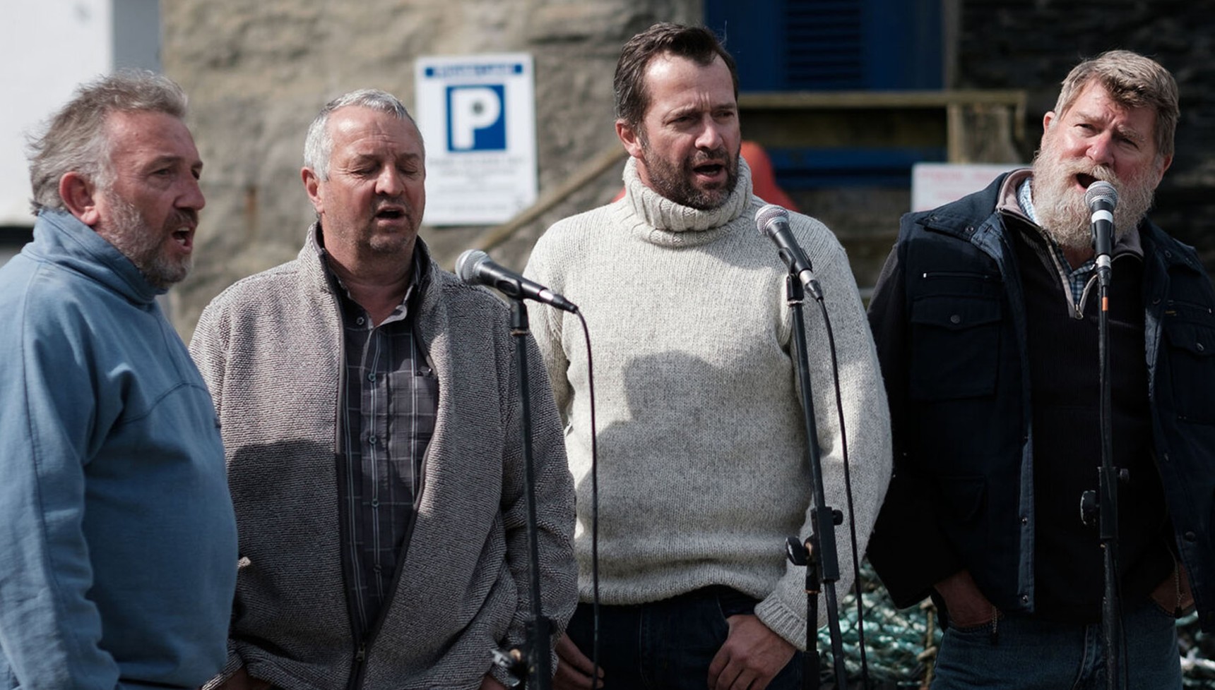 James Purefoy and other men singing in Fisherman's Friends