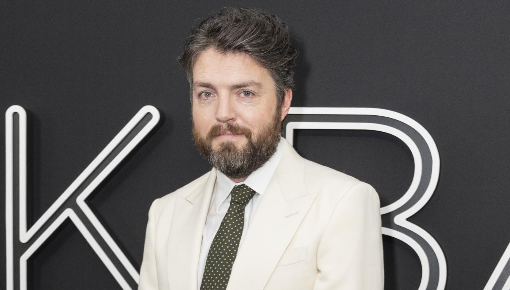 A photo of Tom Burke on the Black Bag carpet