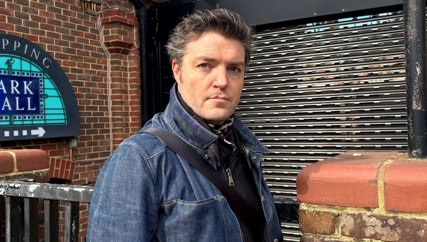 Tom Burke standing in a street in Ashford