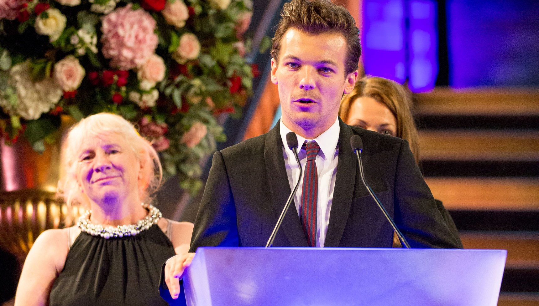 Louis Tomlinson with Jean O'Brien at a Believe in Magic event