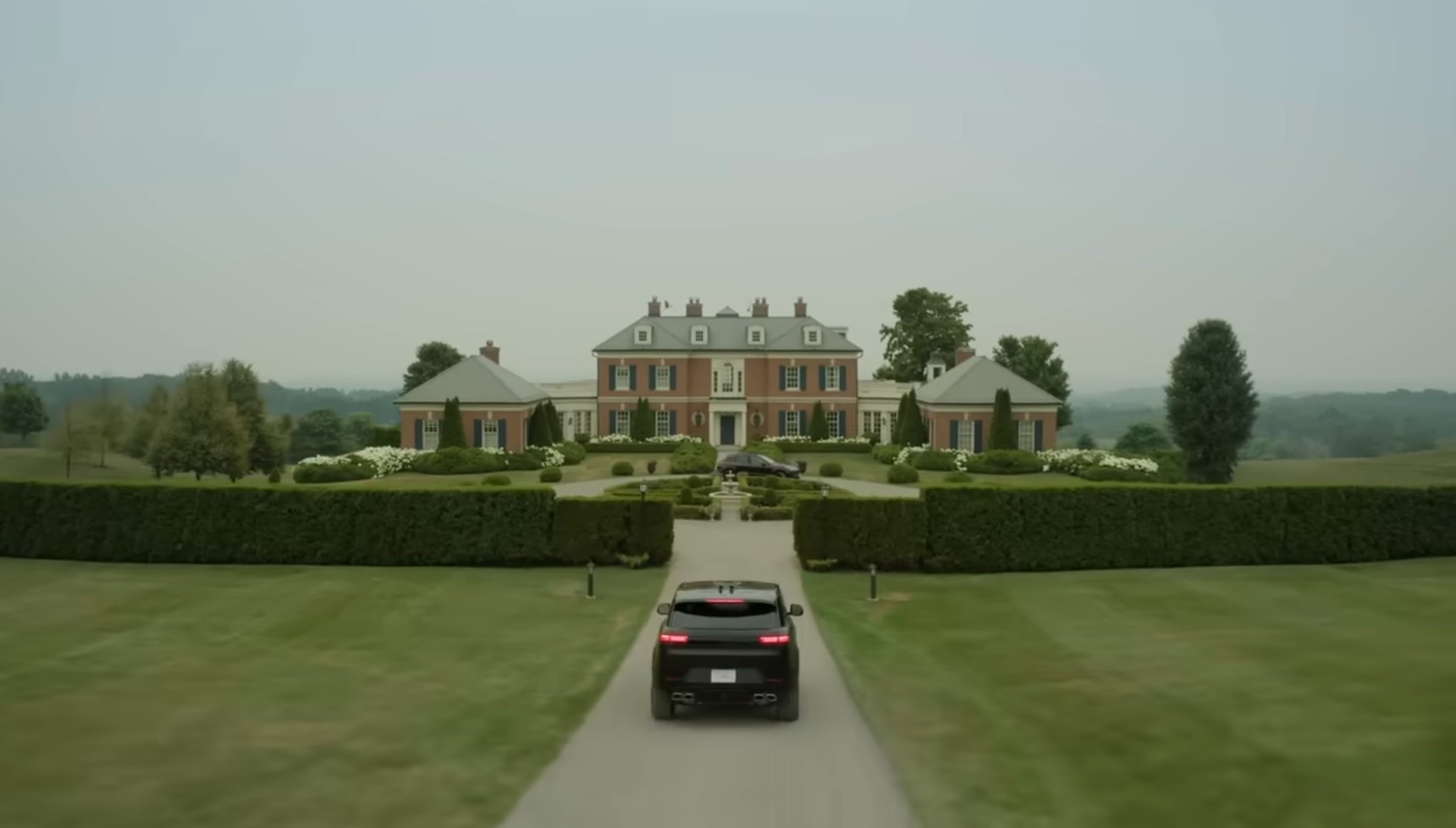 Escarpment House in Caledon, Ontario, a luxury estate featuring red brick construction and extensive landscaped gardens.