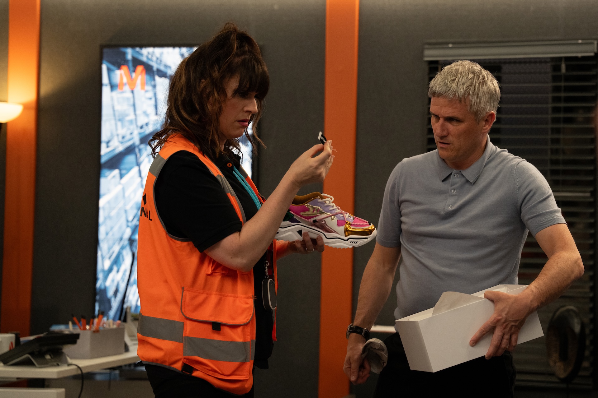 Emmerdale's Kerry and Caleb inspecting shoe