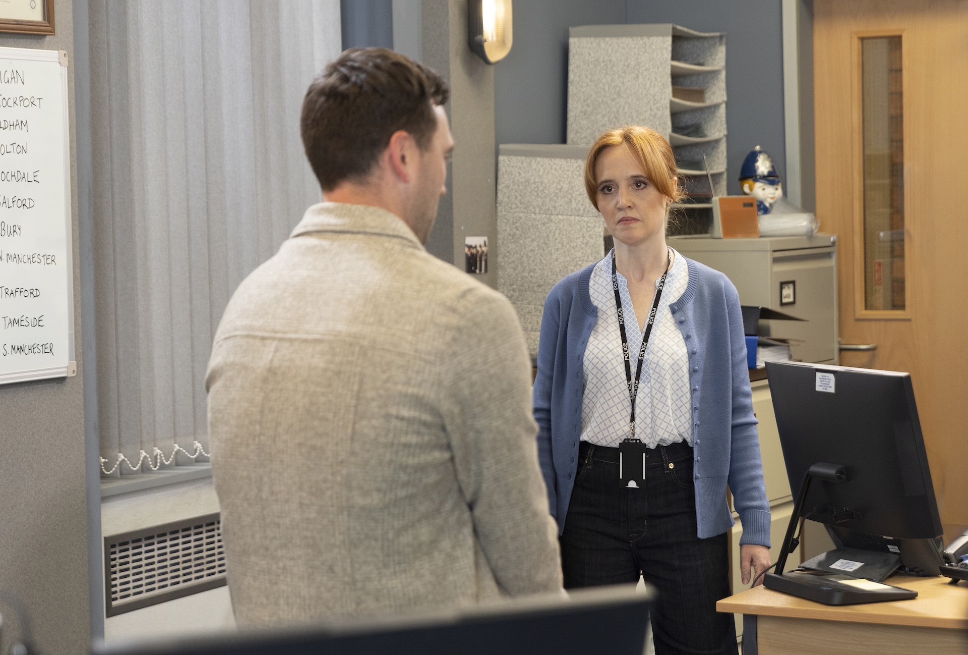 Kit talking to colleague at the police station in Coronation Street
