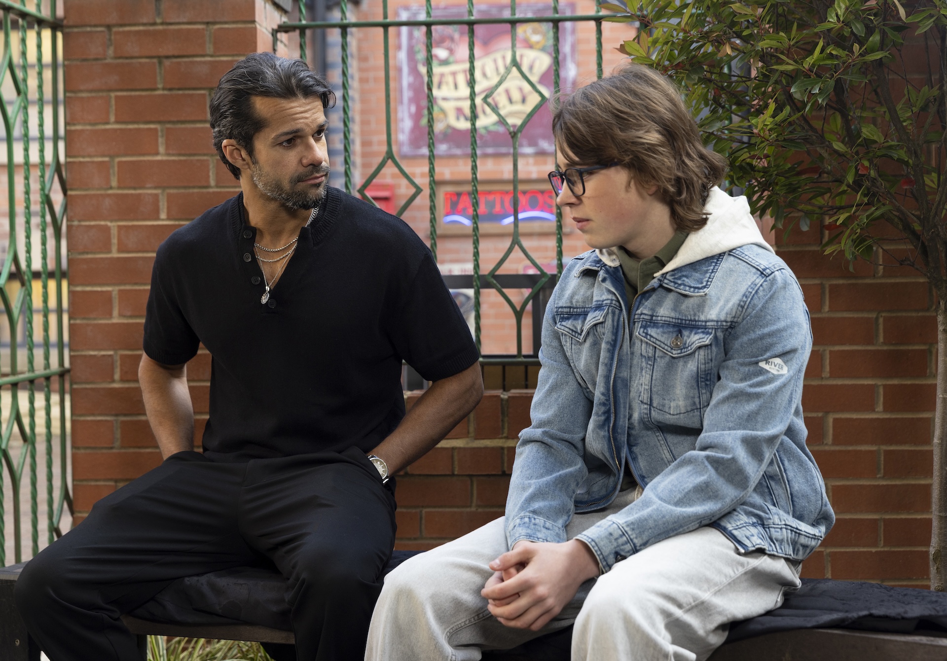 Idris and Sam sitting on bench in Coronation Street