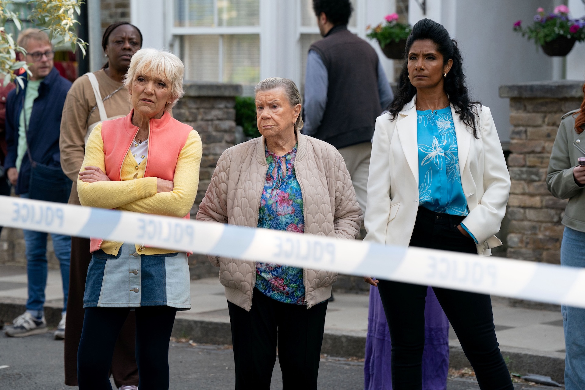 Jean, Mo and Suki by police cordon in EastEnders