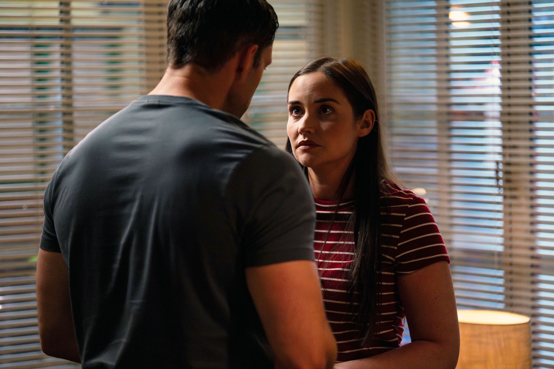 Lauren looking into Mark's eyes as they stand close