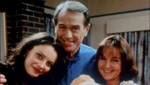 Terence Donovan beside two co-stars on Neighbours, smiling