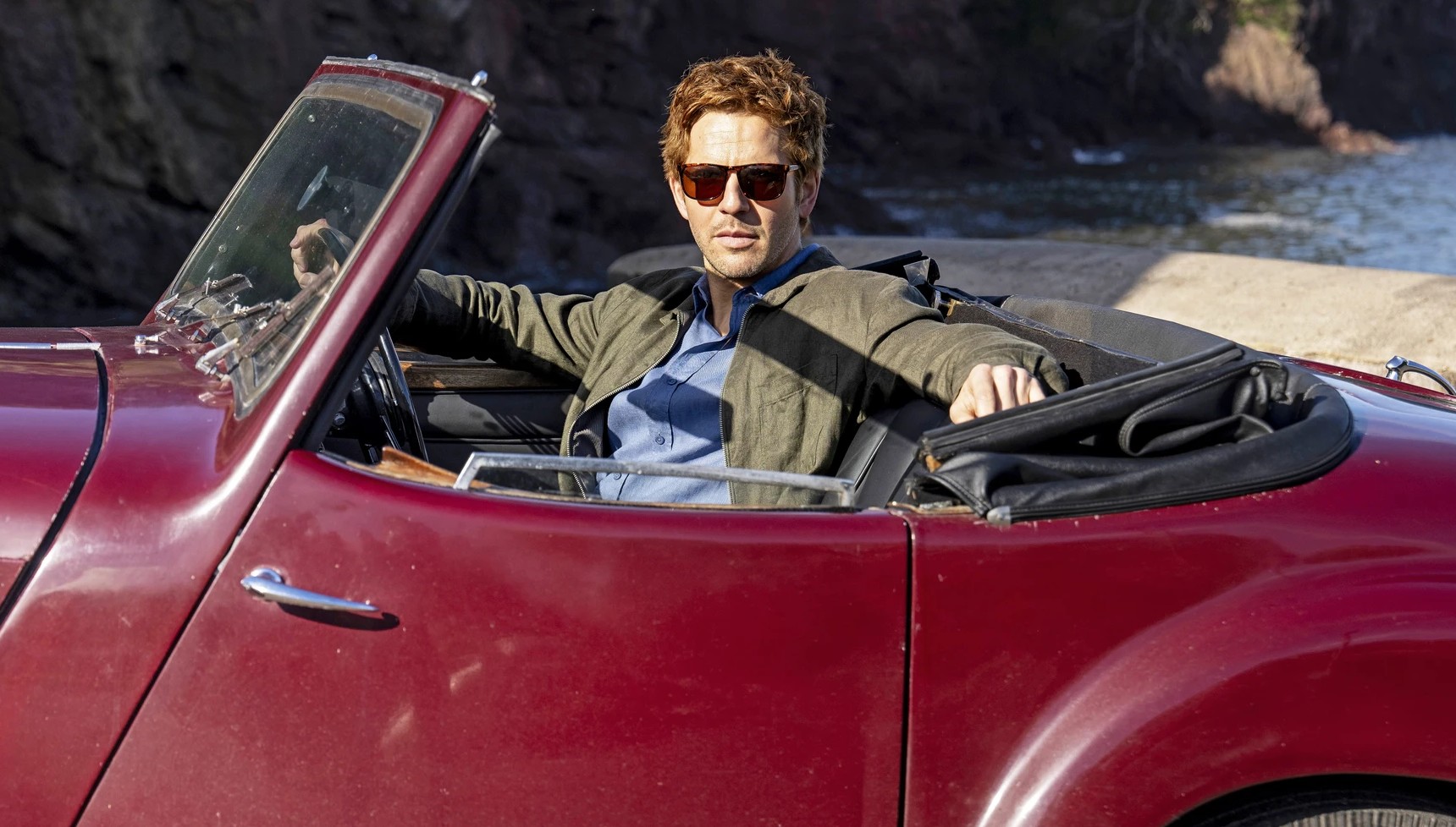 Damien Molony as Jim Bergerac in car