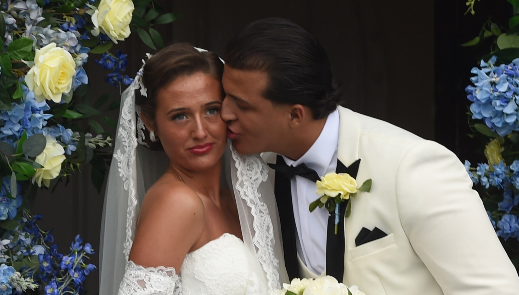 Venezuela Fury smiling as Noah Price kisses her on wedding day