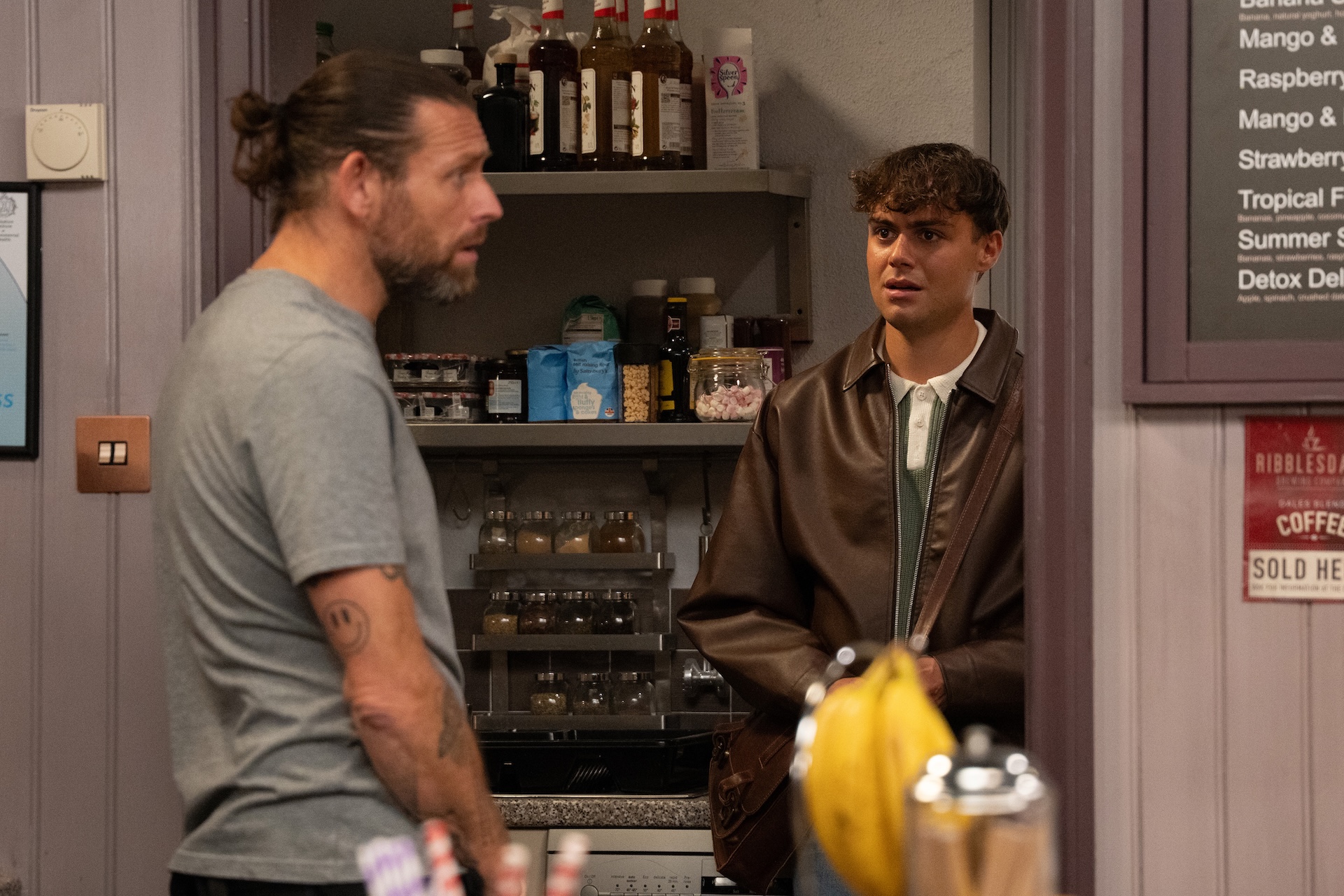 Lewis speaking to Kev in the cafe 
