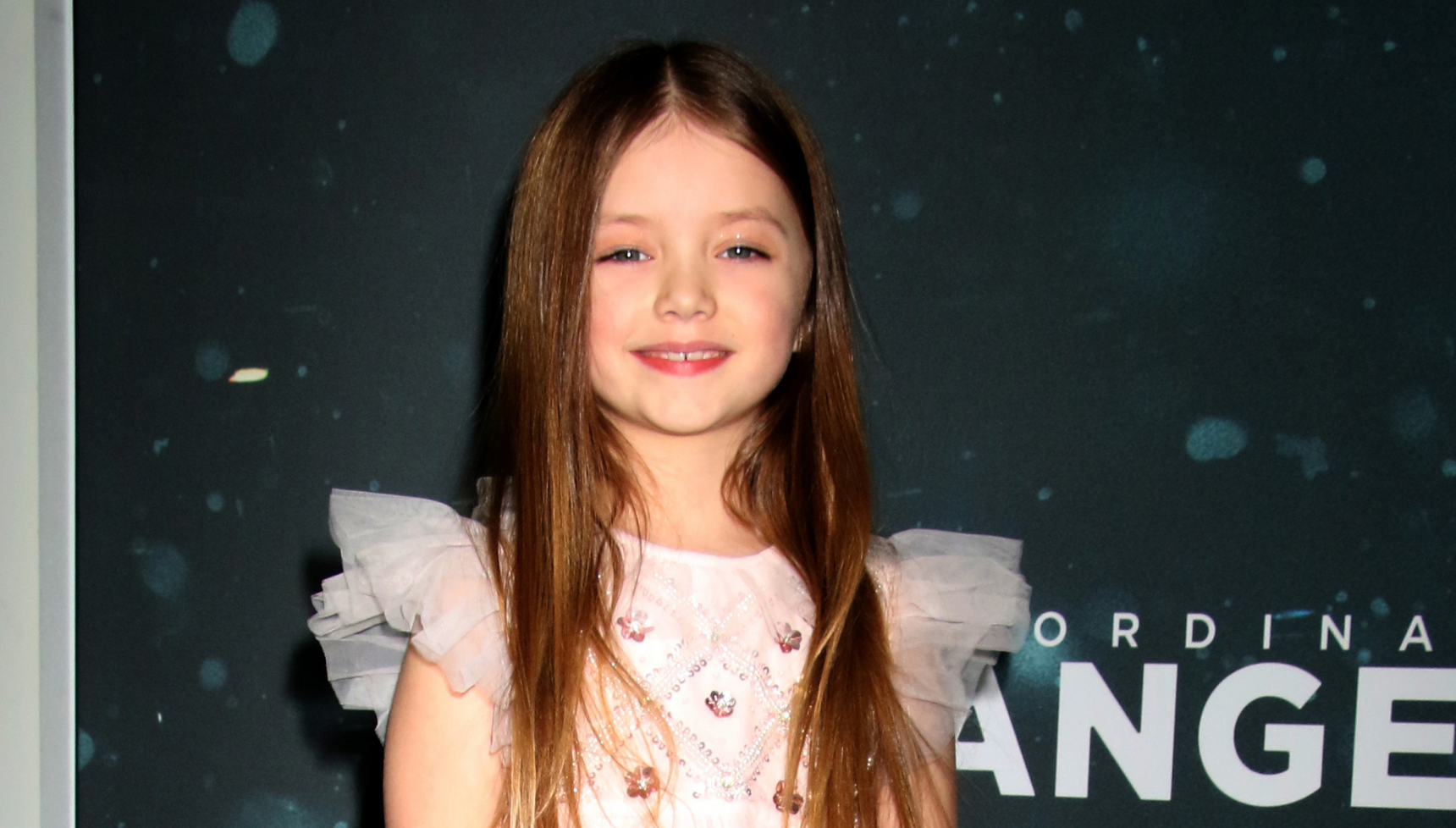 Emily Mitchell wears pink dress on red carpet