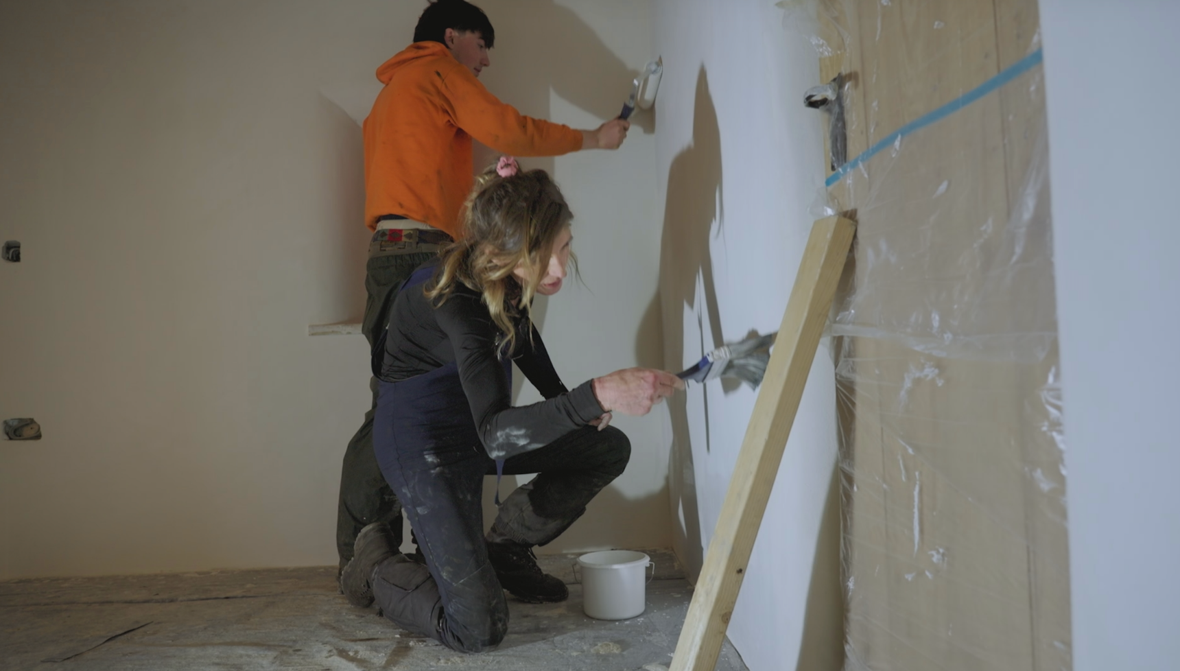 Amanda and Miles Owen painting a wall