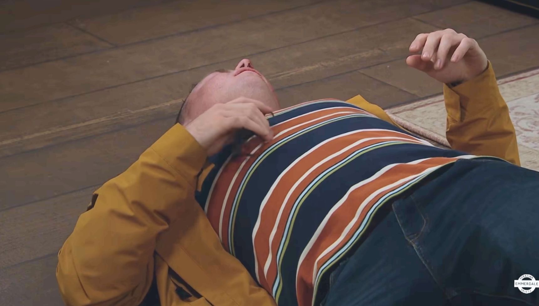 Vinny lying on the floor with a bloody nose in Emmerdale