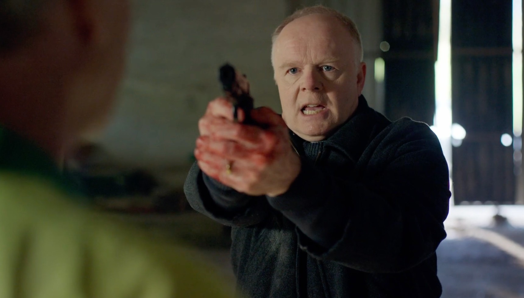 Huw pointing a gun at Patrick in The Game series 2 ending