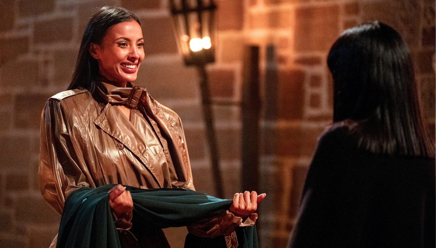 Maya Jama receiving cloak